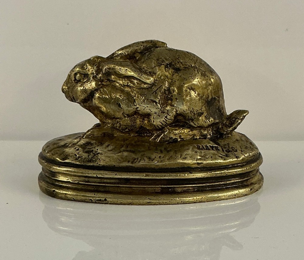 A small 19th-century gilt bronze sculpture depicting a crouching rabbit on an oval moulded base. View V