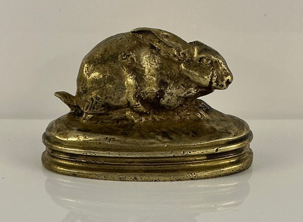 A small 19th-century gilt bronze sculpture depicting a crouching rabbit on an oval moulded base. View VI