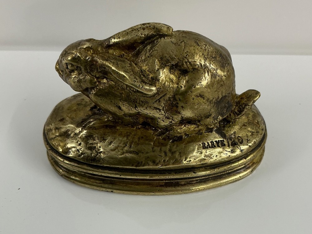 A small 19th-century gilt bronze sculpture depicting a crouching rabbit on an oval moulded base. View VII