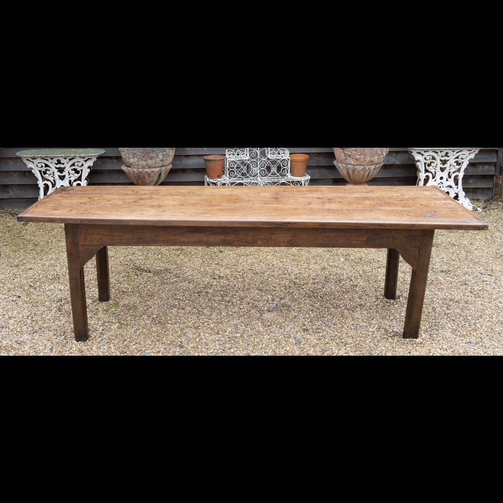 A long rectangular 18th-century solid oak farmhouse dining table with a wide plank top and straight square legs.