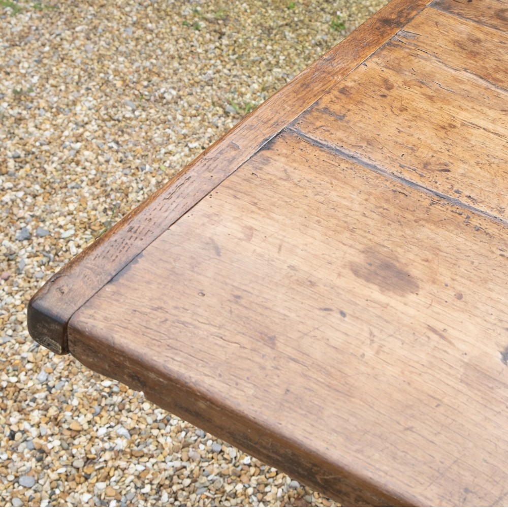 A long rectangular 18th-century solid oak farmhouse dining table with a wide plank top and straight square legs. View II