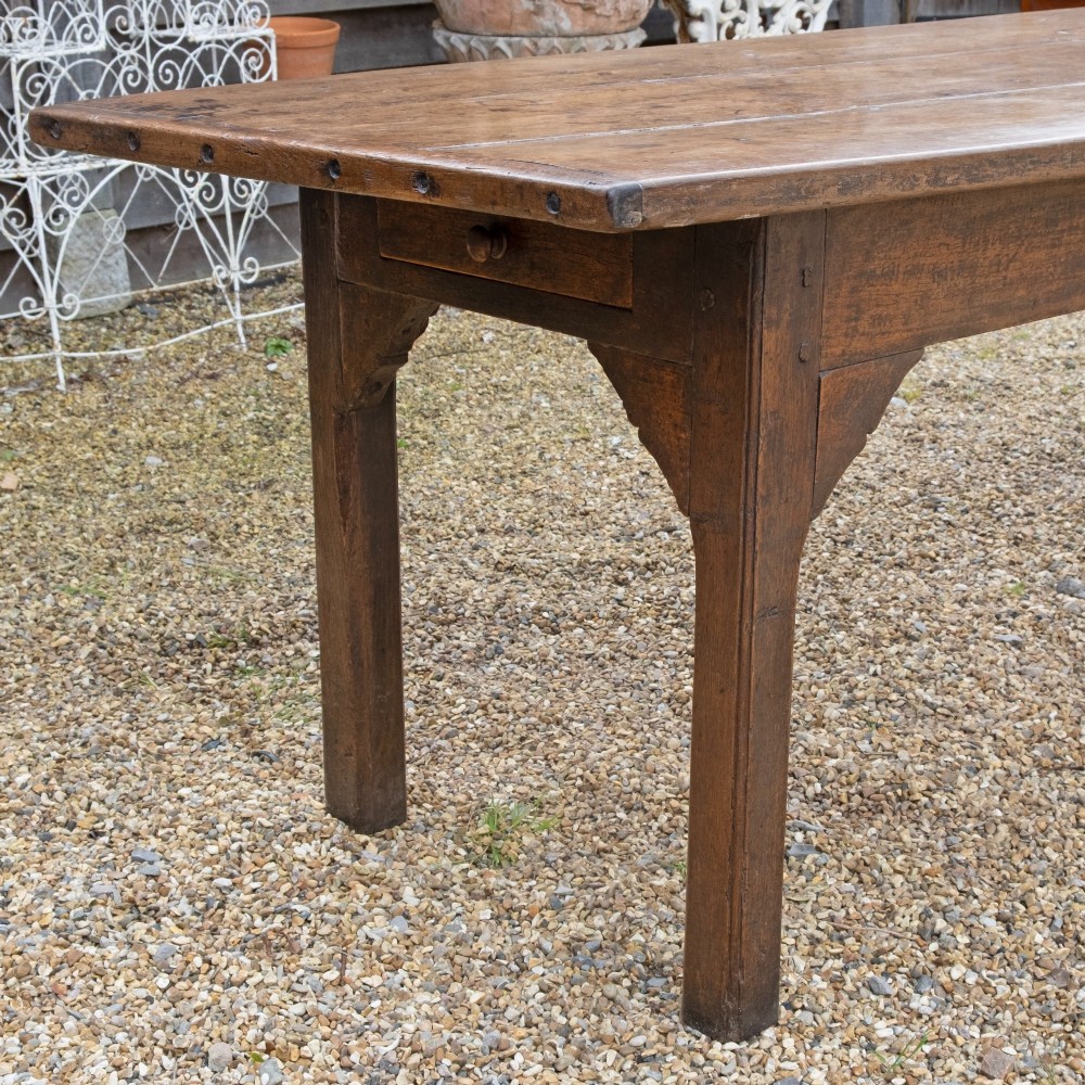 A long rectangular 18th-century solid oak farmhouse dining table with a wide plank top and straight square legs. View IV