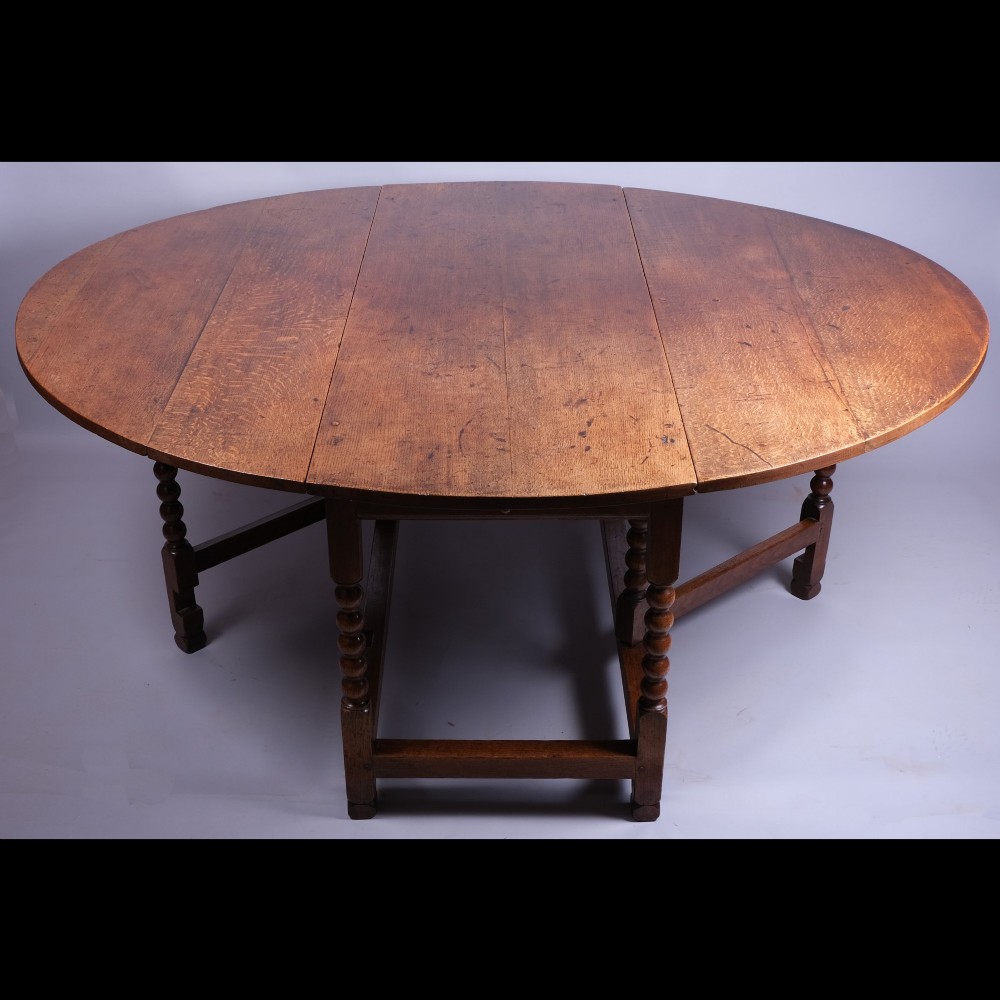 A 17th-century oak gateleg table featuring two drop leaves, bobbin-turned legs, and lower perimeter stretchers. View II