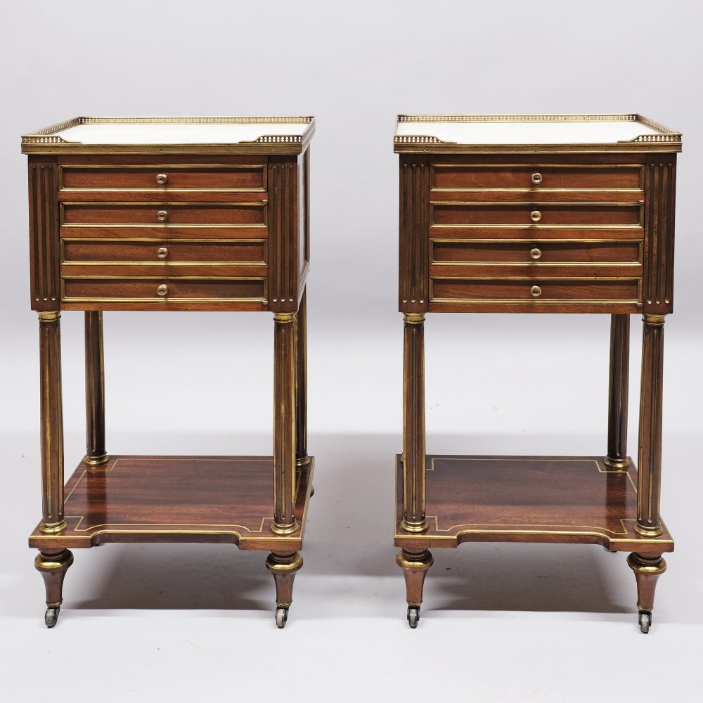 A pair of tall 19th century French Empire mahogany bedside cabinets featuring brass galleries, four drawers with brass mouldings, fluted legs, and lower shelves. View IV