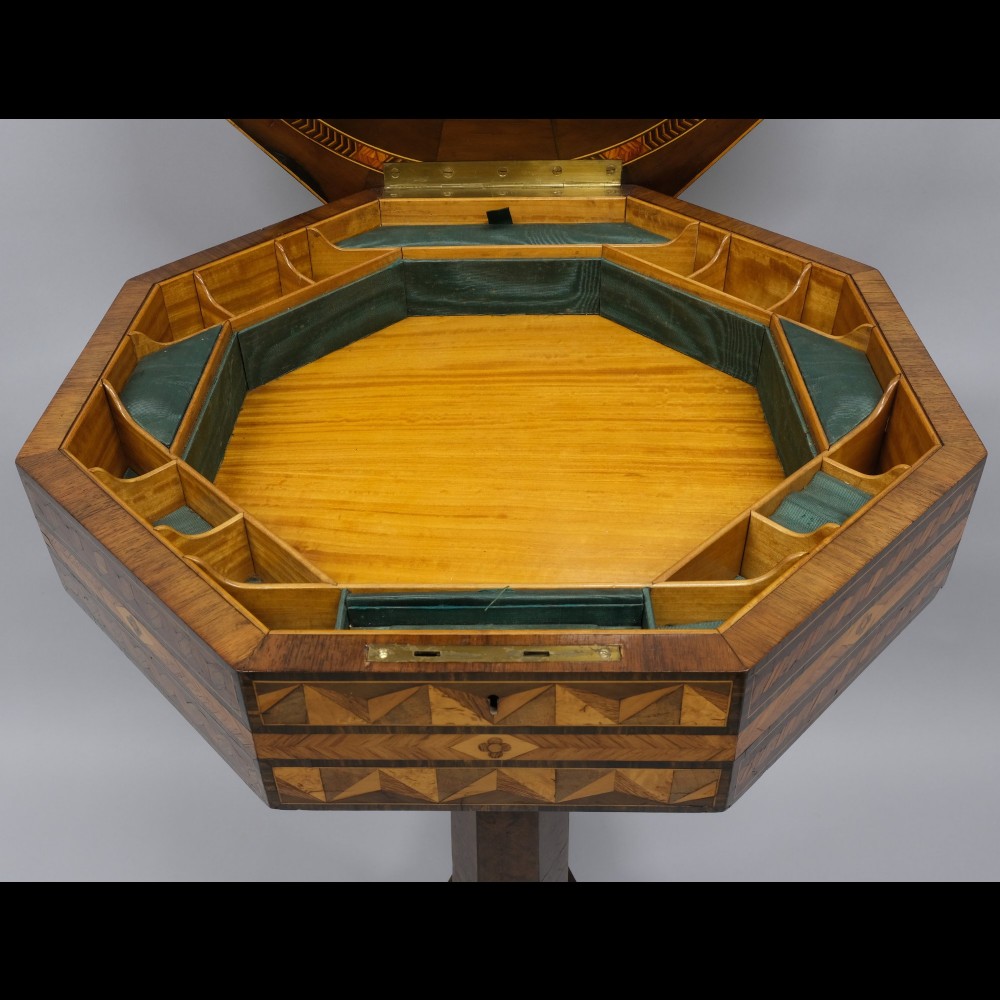 An early 19th-century octagonal work table featuring intricate geometric parquetry inlay, a faceted central column, and carved claw feet. View III