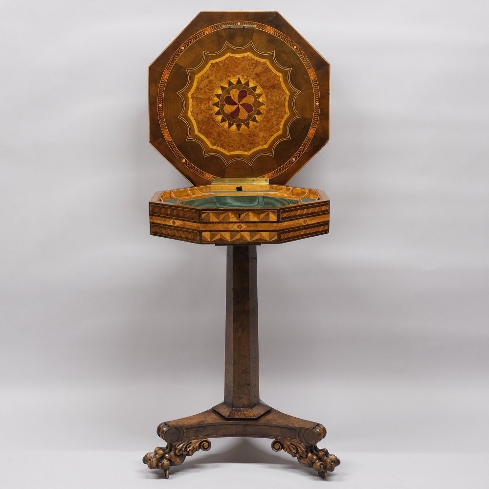 An early 19th-century octagonal work table featuring intricate geometric parquetry inlay, a faceted central column, and carved claw feet. View V