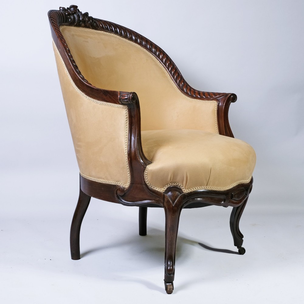 A pair of 19th-century armchairs crafted from dark Goncalo Alves wood featuring hand-carved showwood frames and cream velvet upholstery. View II
