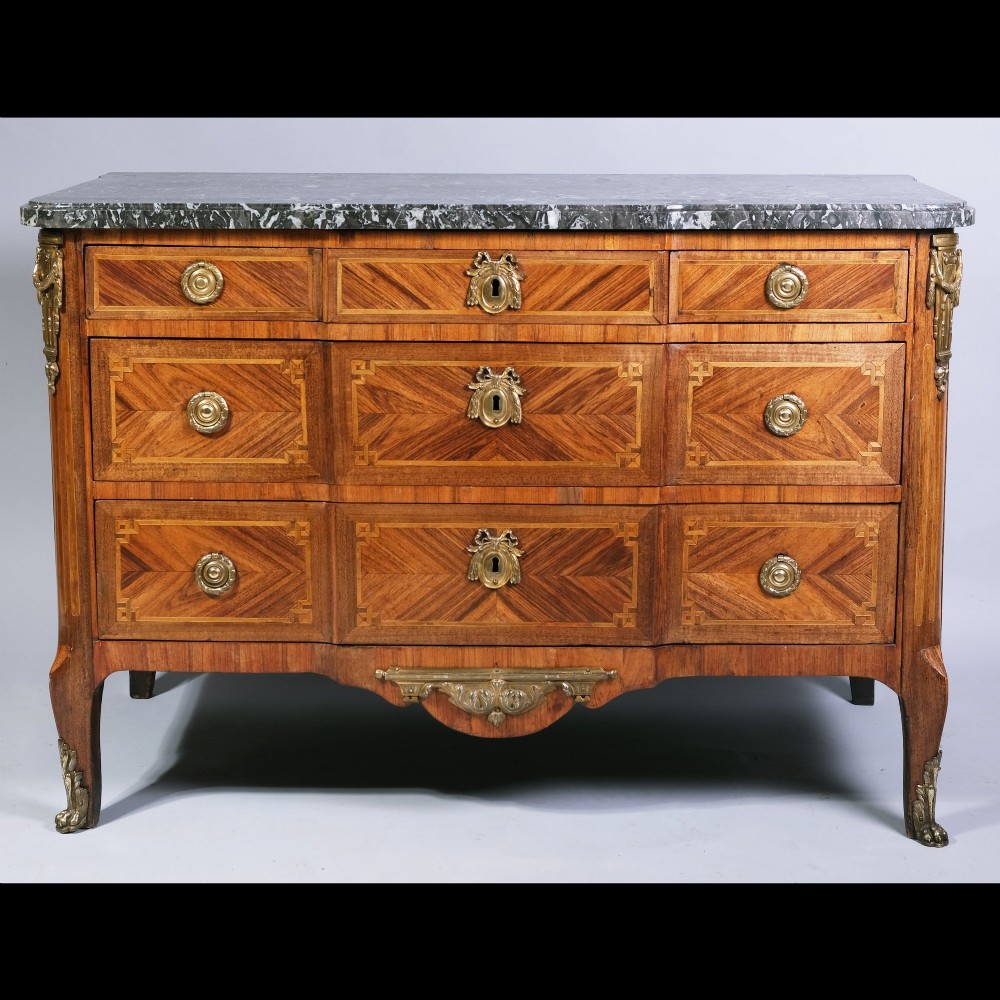 An 18th-century French Louis XVI walnut parquetry commode featuring three drawers with gilt bronze hardware and a grey marble top surface.