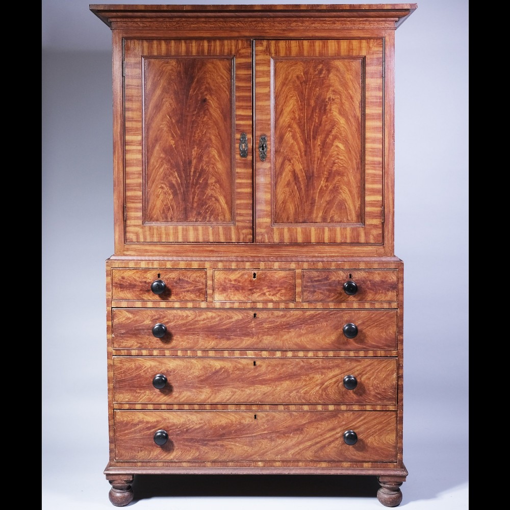 A 19th-century scumble-painted housekeepers cupboard with two upper cupboard doors and four lower drawers with black turned knobs.