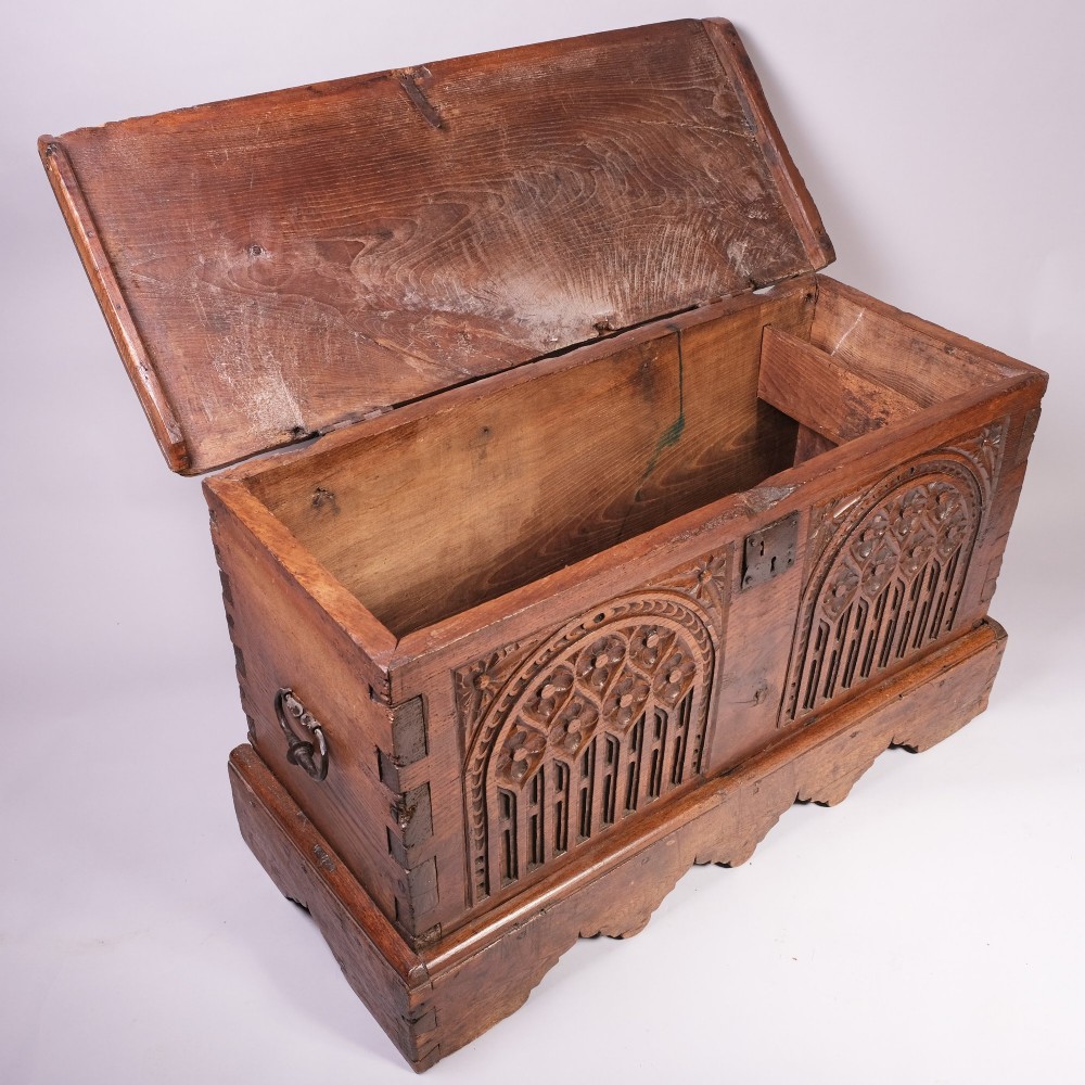 An antique oak and elm coffer featuring carved Gothic tracery arches across the front panel and a hand-forged iron lockplate. View IV