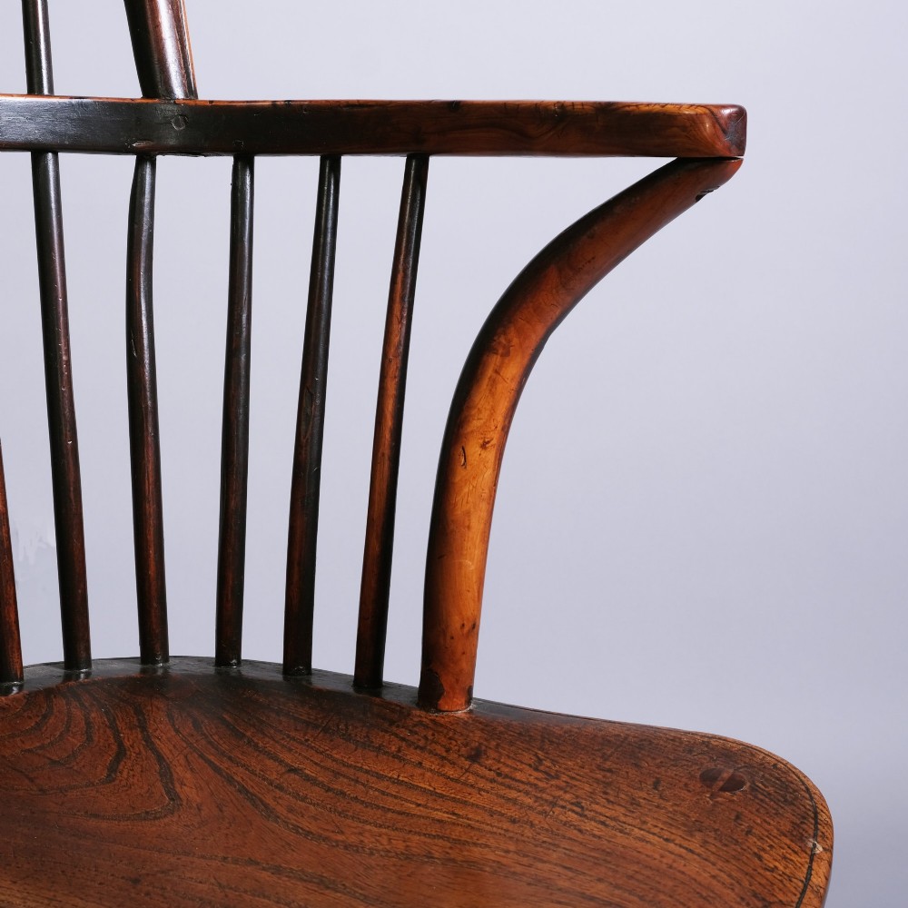 An early 19th-century Windsor armchair crafted from yew and ash wood, featuring a hoop back, pierced splat, shaped seat, and turned legs. View III