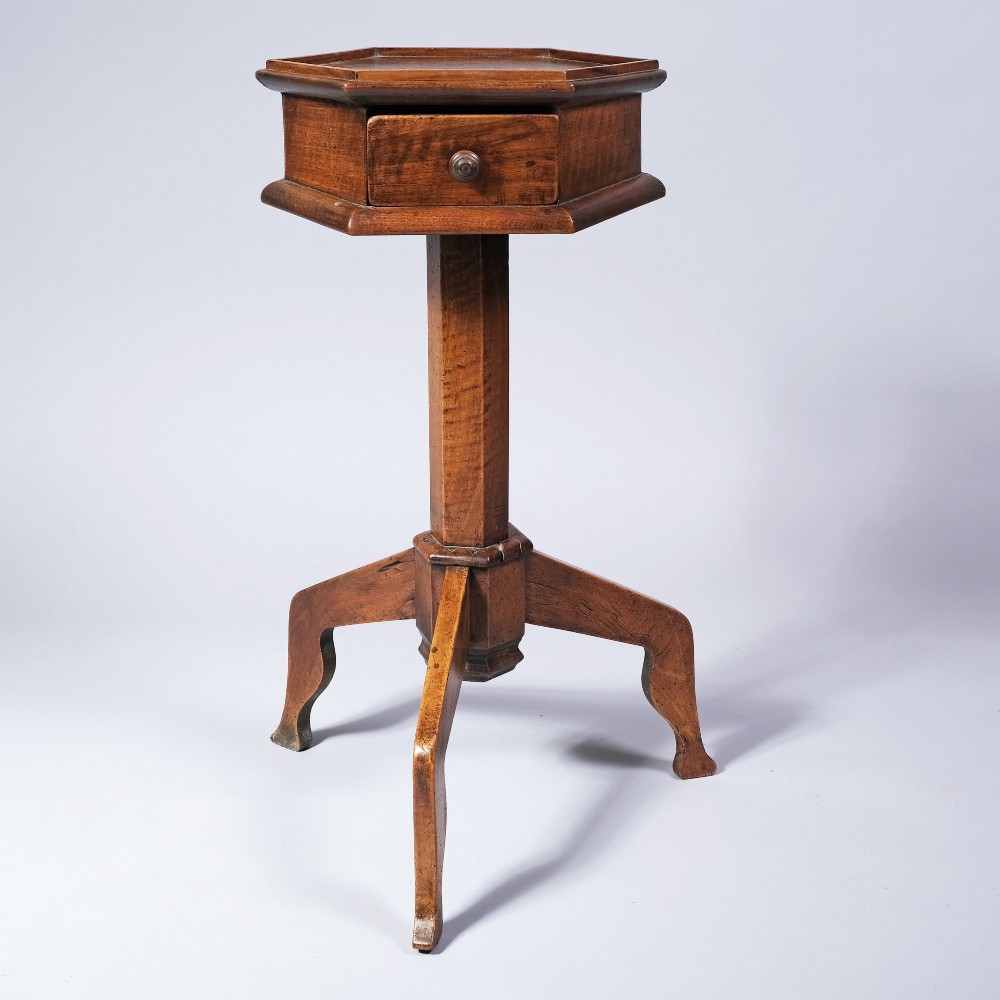 An early nineteenth-century fruitwood occasional table featuring an octagonal top with a single drawer on three downswept tripod legs.