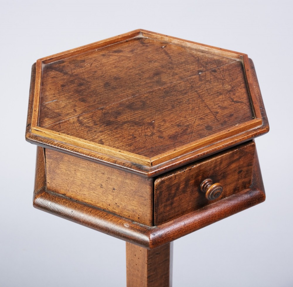 An early nineteenth-century fruitwood occasional table featuring an octagonal top with a single drawer on three downswept tripod legs. View II