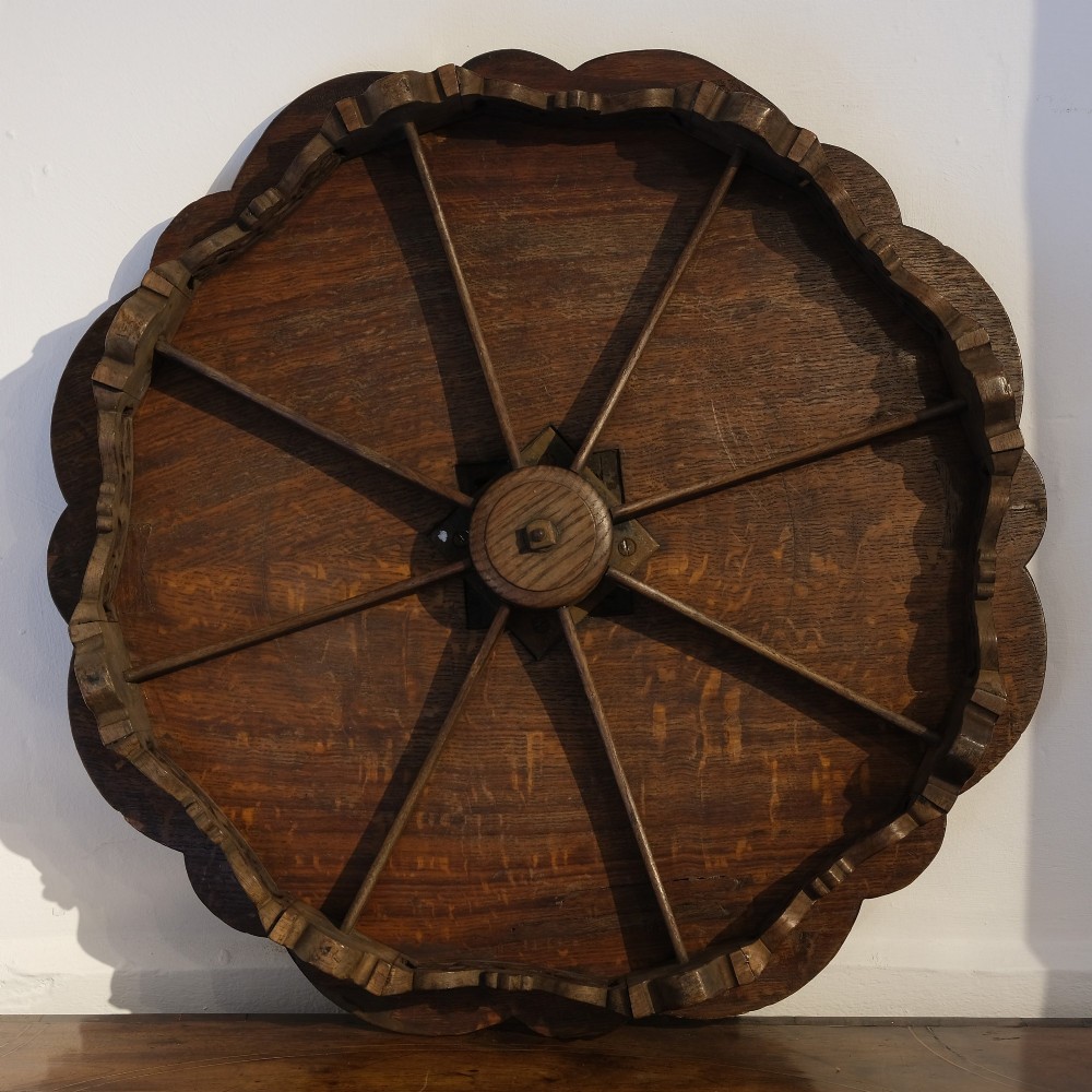 A circular carved dark oak lazy susan featuring eight recessed round dish compartments surrounding a central tray with carved floral rim accents. View II