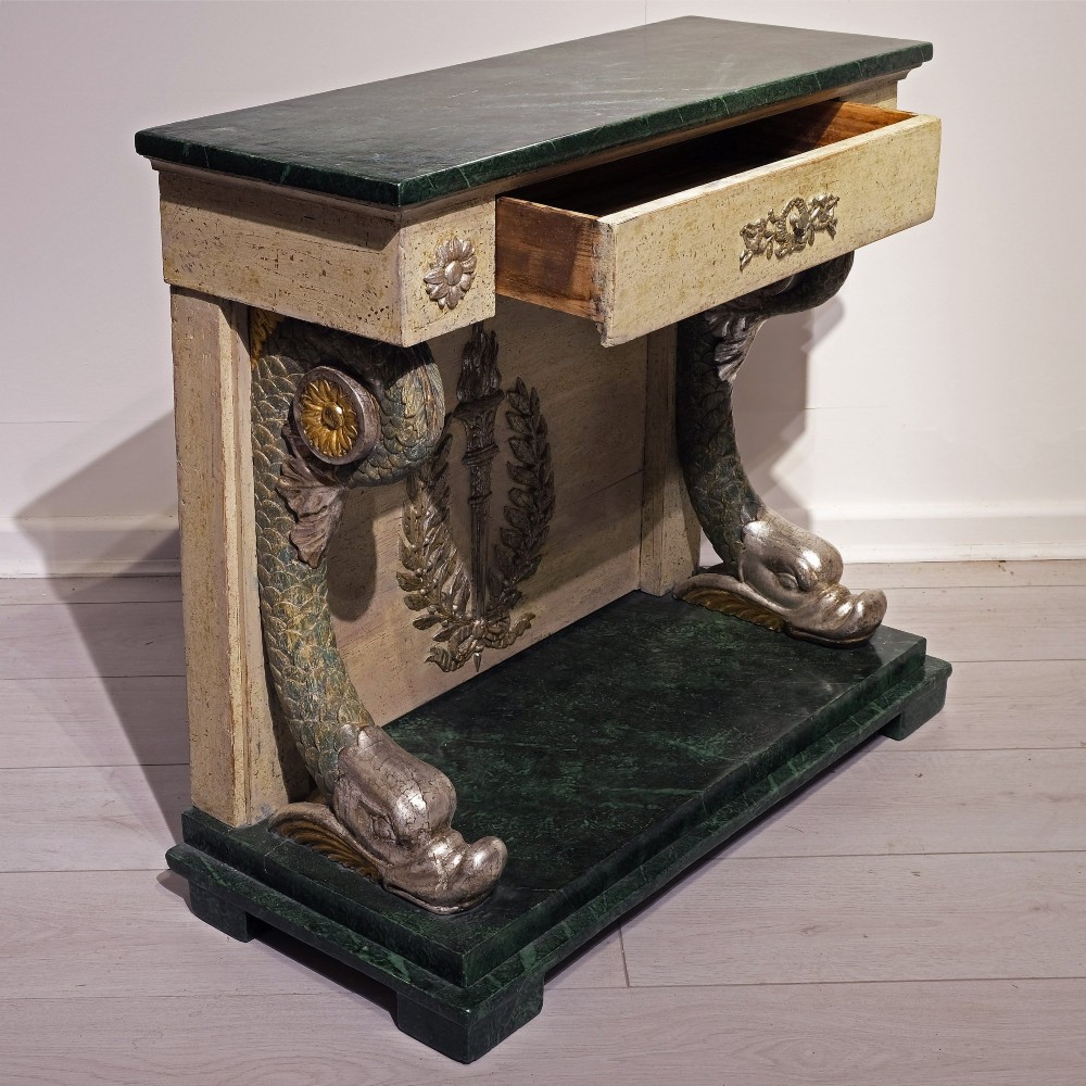 A late 18th-century Gustavian console table with a green marble top, cream painted finish, carved rosettes, scrolled legs, and a back panel featuring a carved torch with a laurel wreath motif. View III