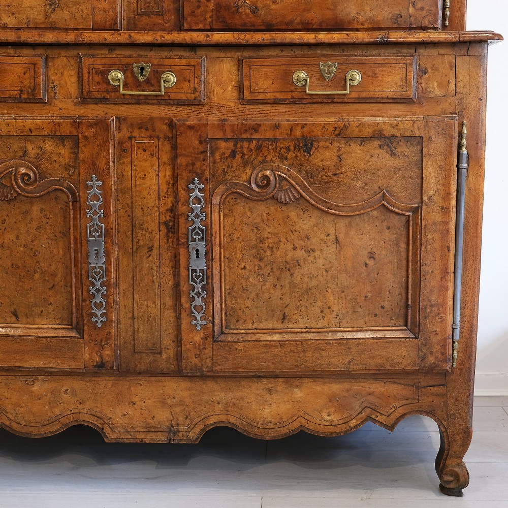 An 18th-century French provincial ash and elm two-part buffet deux corps cabinet featuring carved fielded panels, steel escutcheons, and long barrel hinges. View II