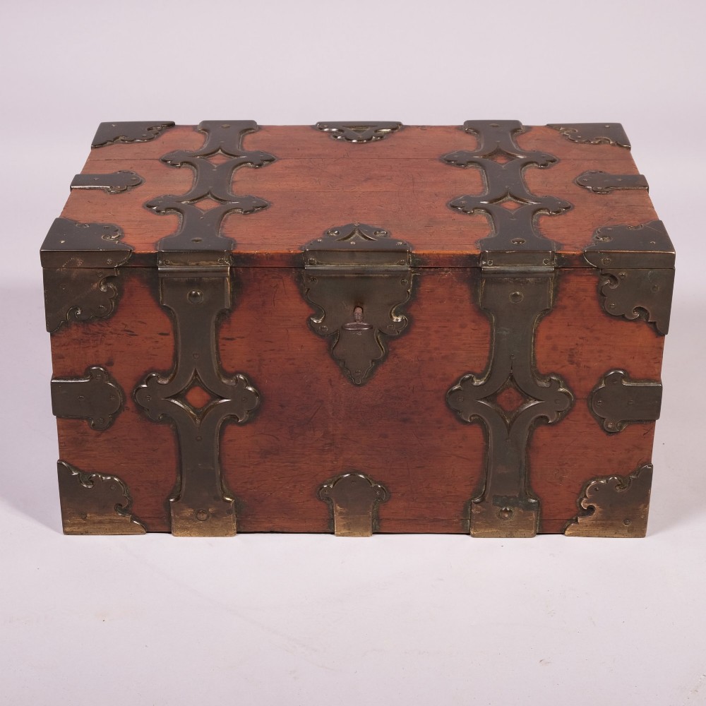 An early eighteenth-century rectangular camphor wood casket featuring ornate cut-out brass strapwork, corner brackets, and side handles. View II