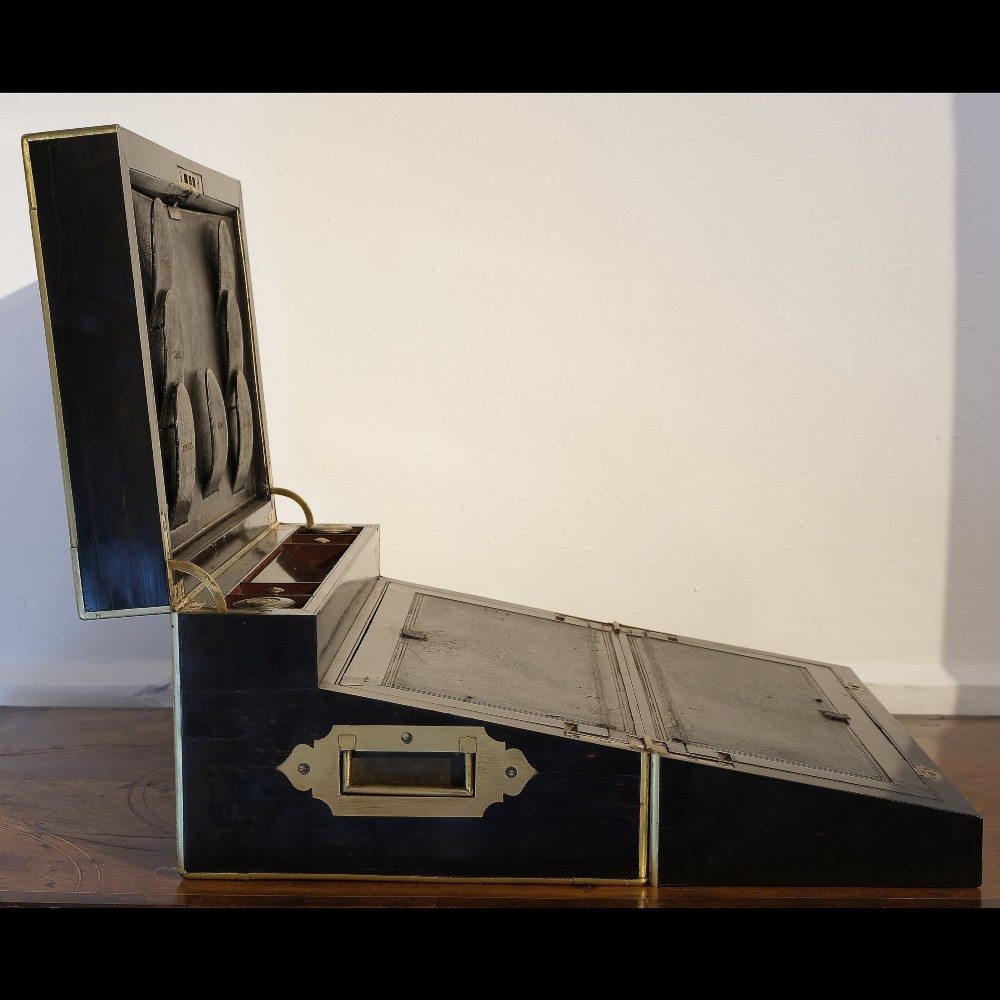 A dark rectangular coromandel wood writing box bound with brass edges, brass stringing inlay, and recessed brass side handles. View III