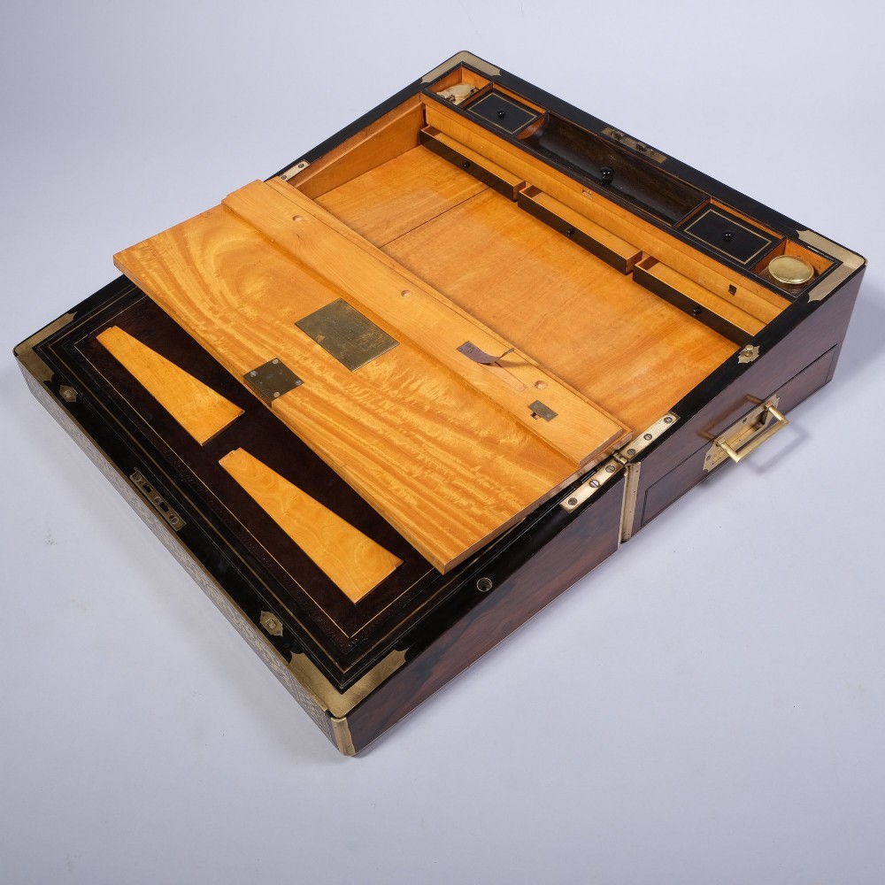 A rectangular dark wood writing box featuring intricate floral brass scrollwork inlay across the top lid and front panel. View III