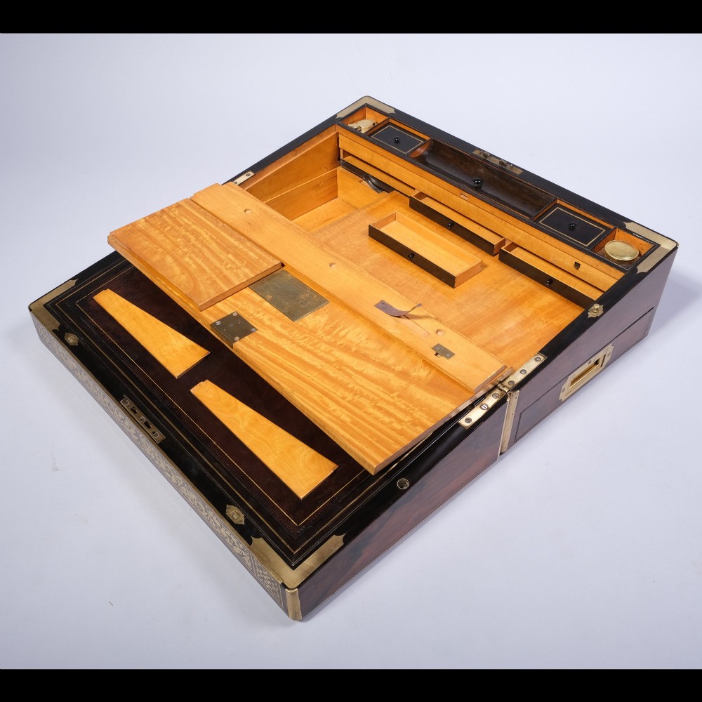 A rectangular dark wood writing box featuring intricate floral brass scrollwork inlay across the top lid and front panel. View IV