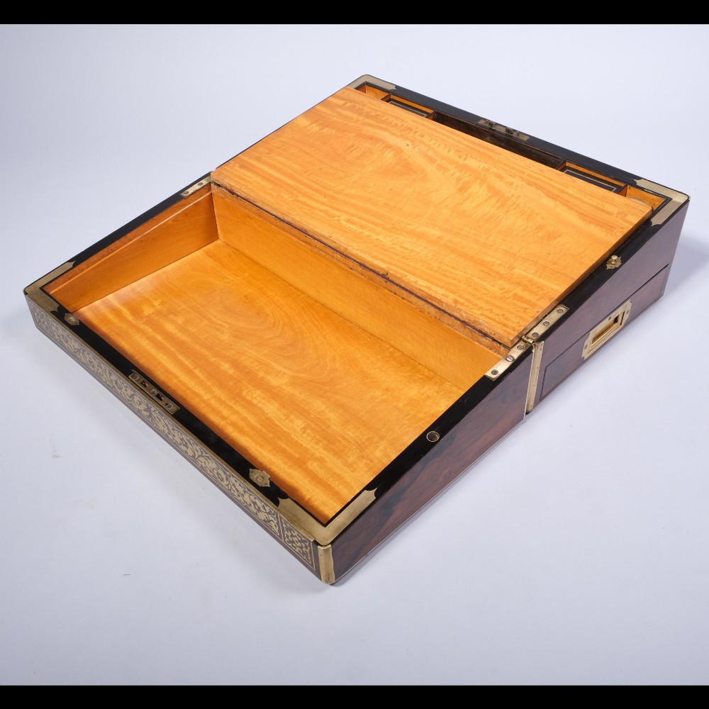 A rectangular dark wood writing box featuring intricate floral brass scrollwork inlay across the top lid and front panel. View V
