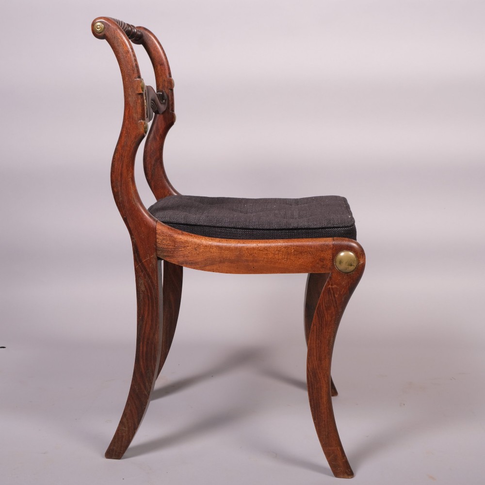 A set of four Regency dining chairs featuring simulated rosewood frames, carved rope twist top rails, brass mounts, and black upholstered seats. View II