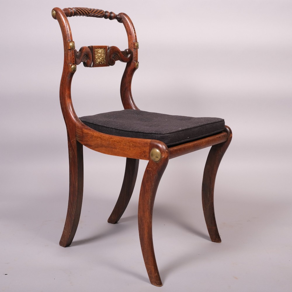 A set of four Regency dining chairs featuring simulated rosewood frames, carved rope twist top rails, brass mounts, and black upholstered seats. View III