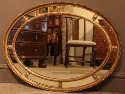 Large Late 19th Century Oval Giltwood and Gesso Adam Style Mirror