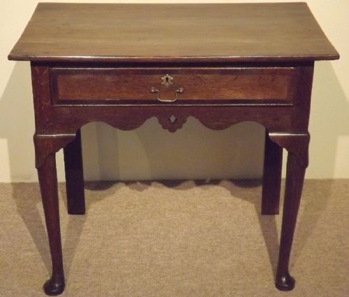 A Mid 18th Century Oak Lowboy on Pad Feet C1750