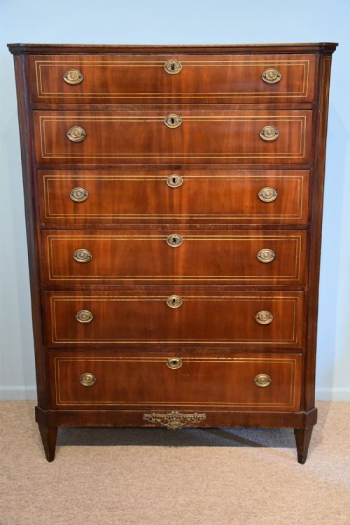 A Mahogany and Brass Inlaid Chest of Drawers