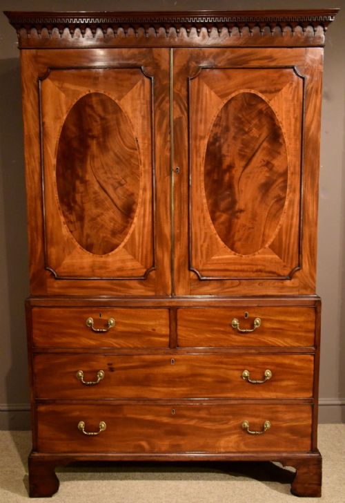 A Handsome George III Mahogany Oval Panelled Linen Press