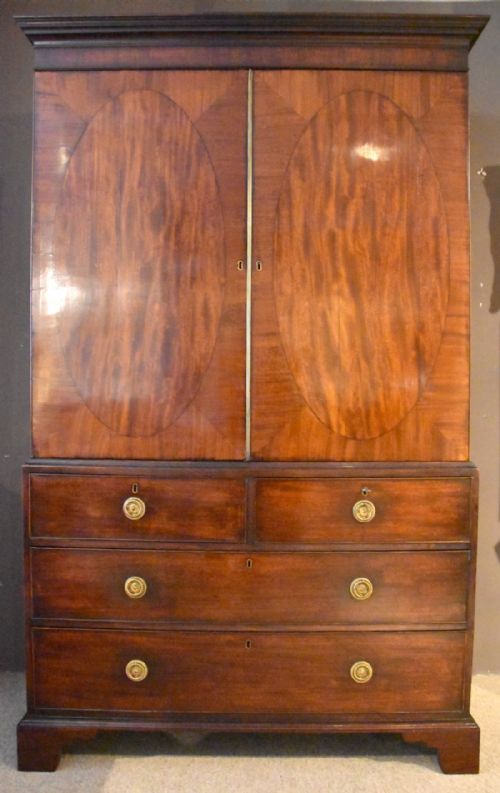 An Elegant George III Mahogany Oval Panelled Linen Press