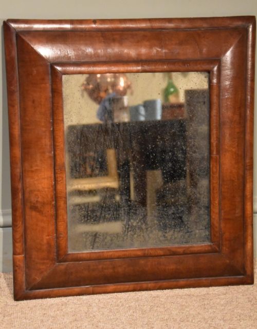 An Early 18th Century Walnut Cushion Frame Mirror