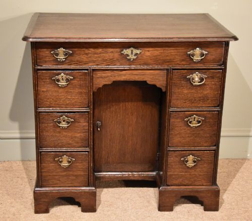 An Unusually Small George I Oak Kneehole Desk