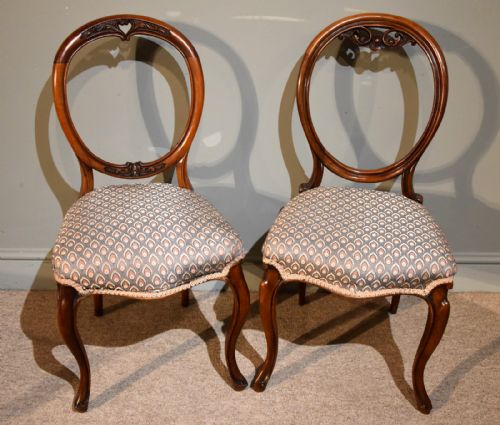 A Near Pair of Mid 19th Century Walnut Balloon Back Chairs