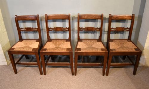 SET OF FOUR EARLY 19TH CENTURY FRUITWOOD DINING CHAIRS