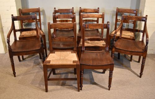 fig 1. A set of six 19th-century warm brown fruitwood dining chairs comprising two carvers and four side chairs with bar backs and turned front legs.