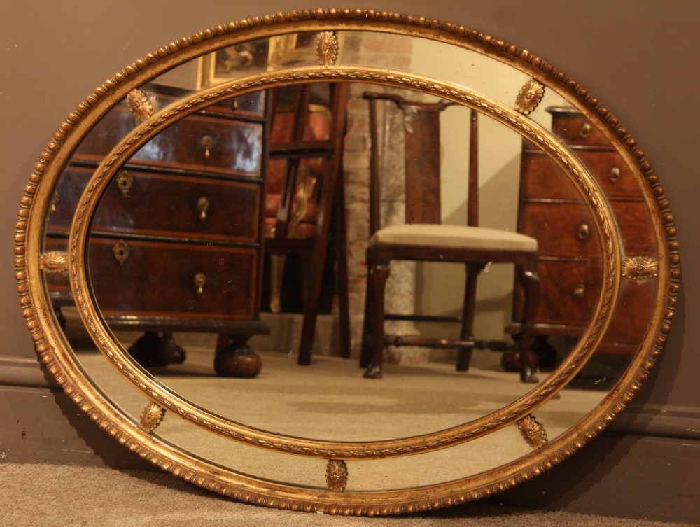 Large Late 19th Century Oval Giltwood and Gesso Adam Style Mirror