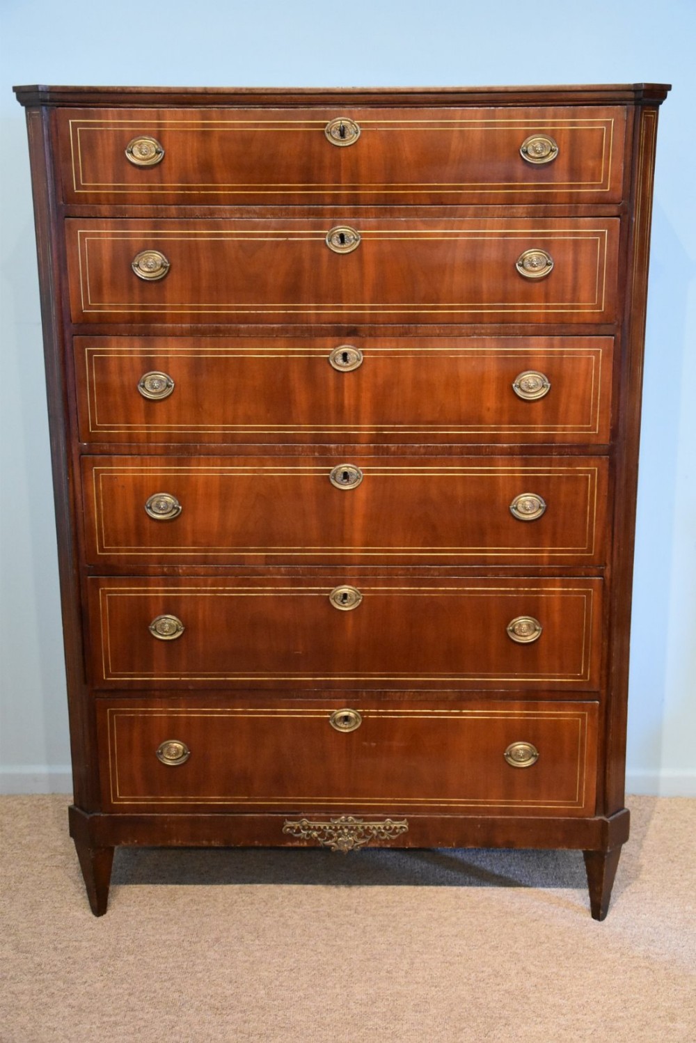 A Mahogany and Brass Inlaid Chest of Drawers