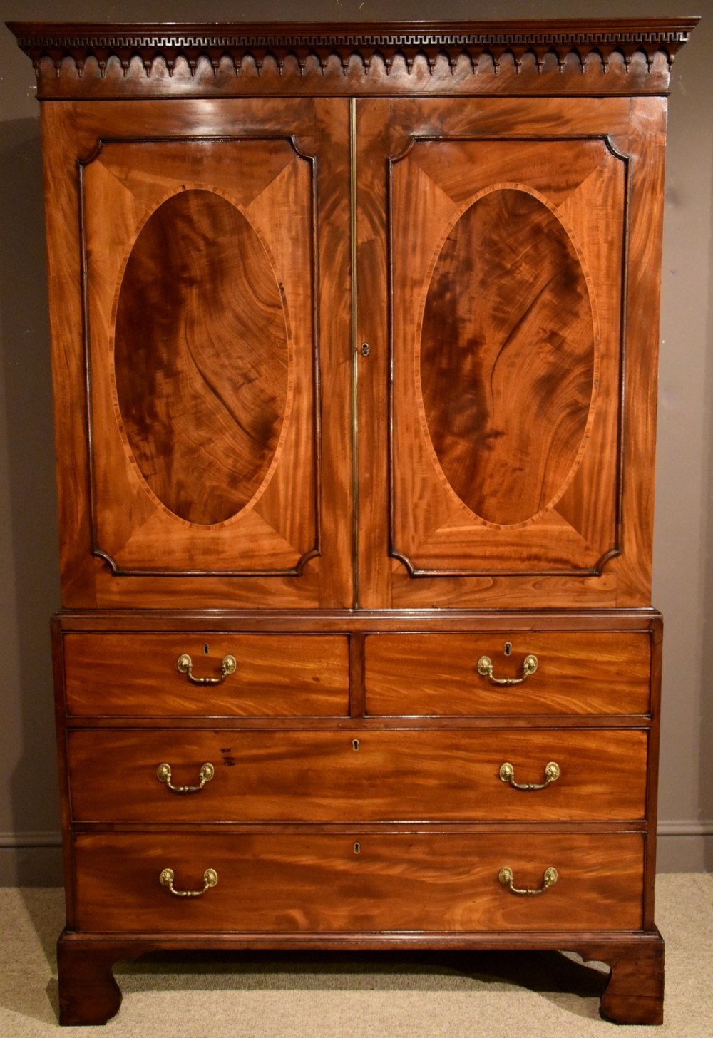 A Handsome George III Mahogany Oval Panelled Linen Press