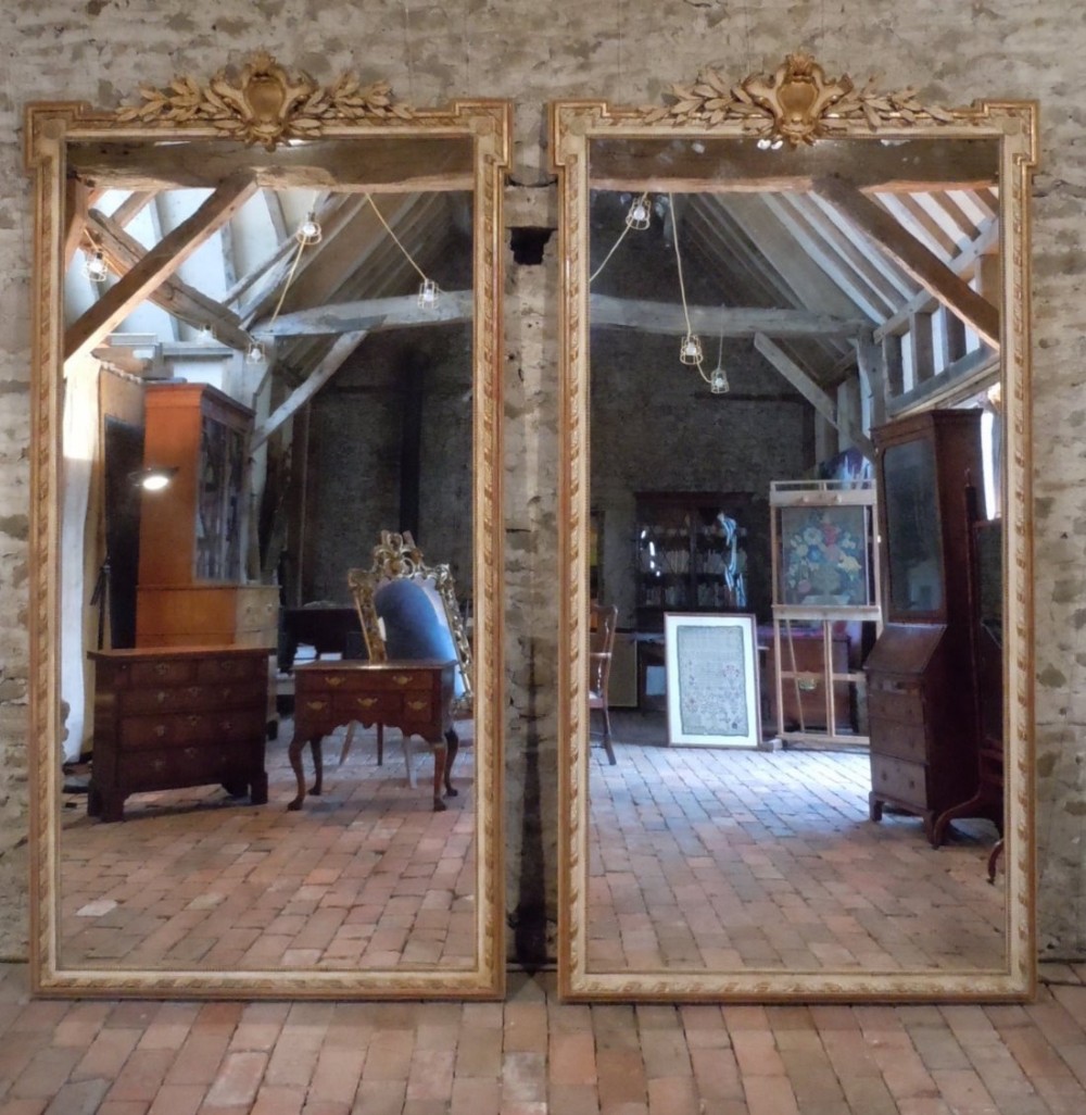 A Rare Pair of Large Mid 19th Century French Parcel Gilt and Ivory Painted Pier Mirrors