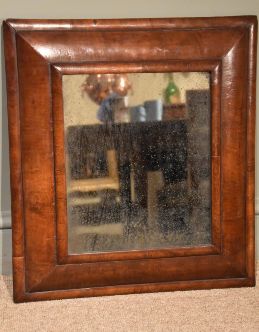 An Early 18th Century Walnut Cushion Frame Mirror