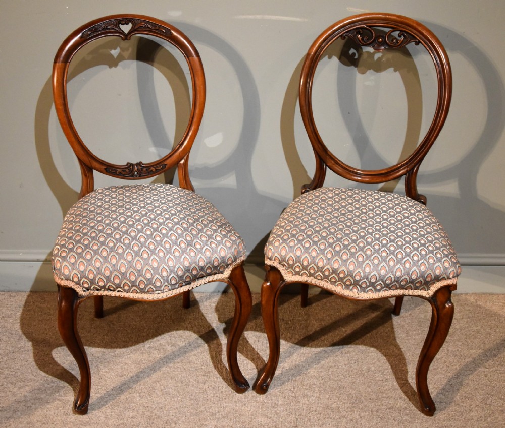 A Near Pair of Mid 19th Century Walnut Balloon Back Chairs 