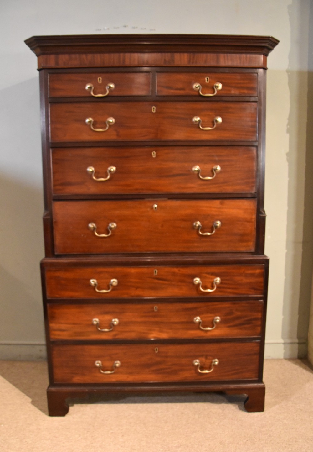 A George III mahogany chest on chest with an open secretaire drawer displaying small internal drawers, pigeonholes, and a green writing surface. View II