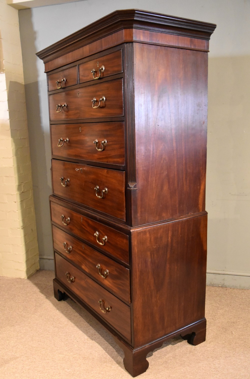 A George III mahogany chest on chest with an open secretaire drawer displaying small internal drawers, pigeonholes, and a green writing surface. View X