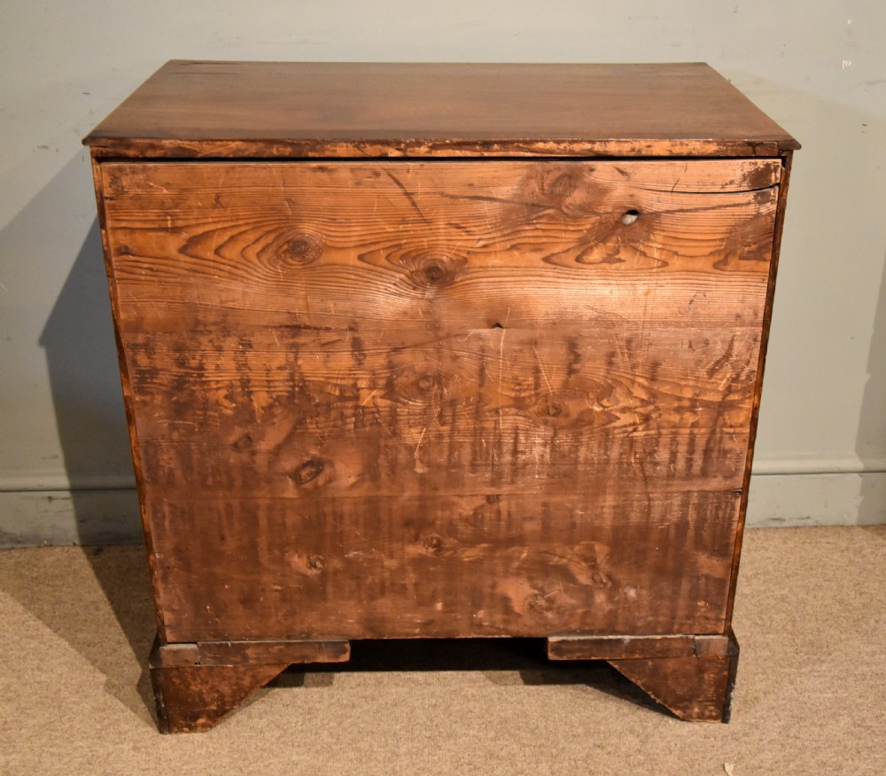 A George III mahogany chest of drawers featuring four graduated drawers with oval brass plate handles and shaped bracket feet. View VIII