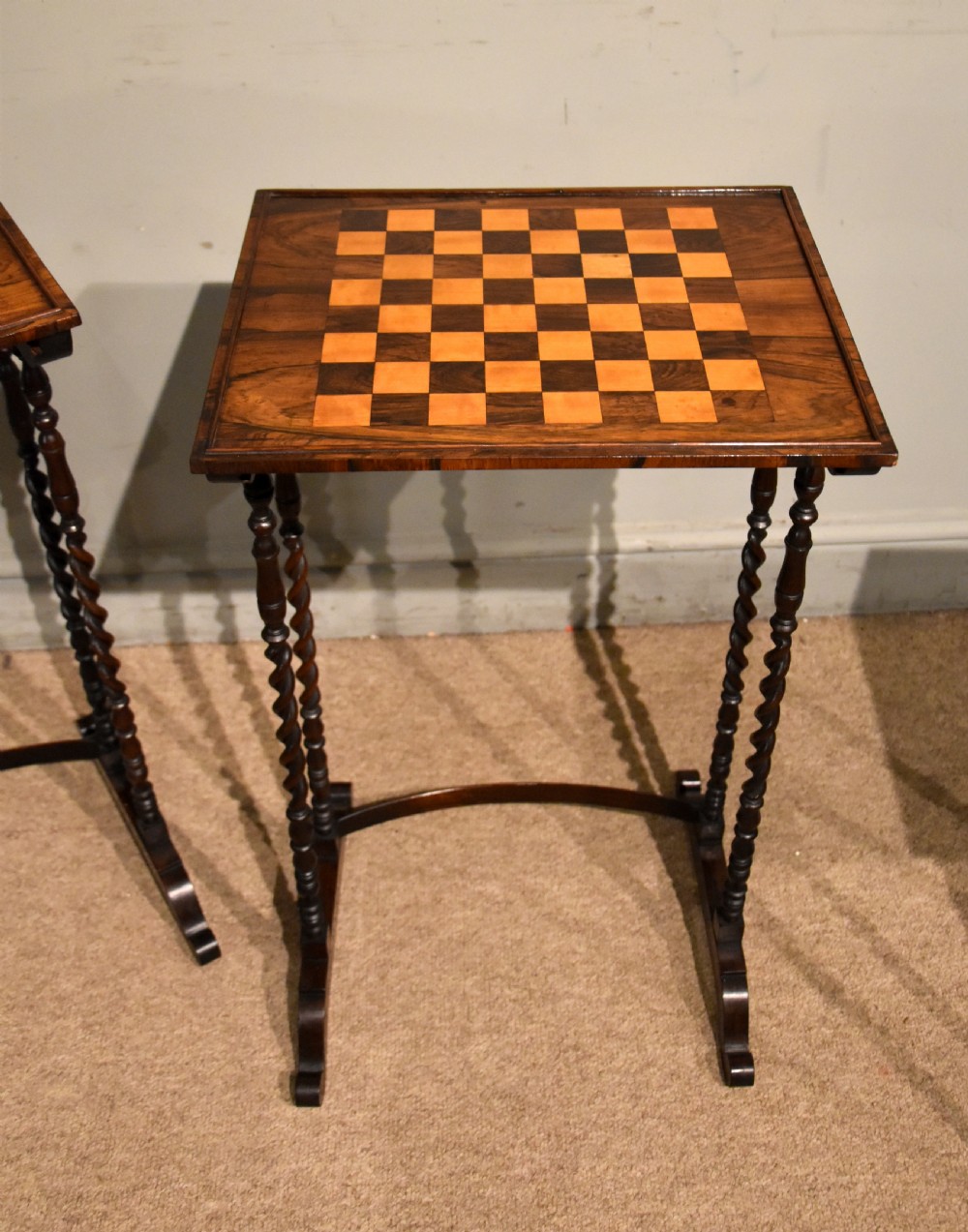 A set of three nested Regency rosewood occasional tables featuring barley twist legs, curved stretchers, and an inlaid chessboard top on the middle table. View III