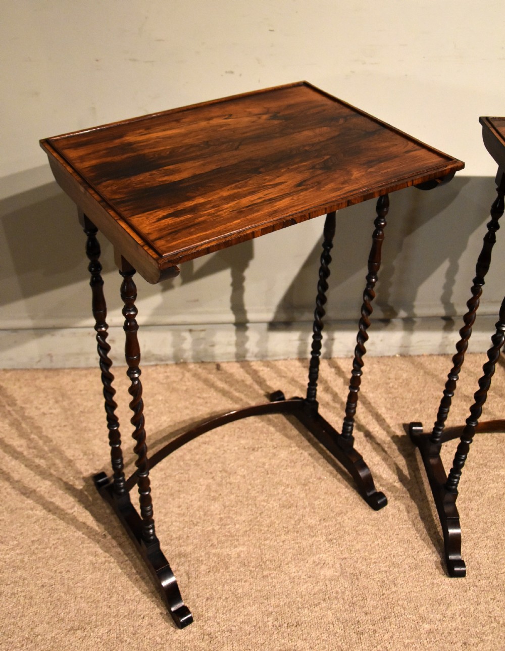 A set of three nested Regency rosewood occasional tables featuring barley twist legs, curved stretchers, and an inlaid chessboard top on the middle table. View IV