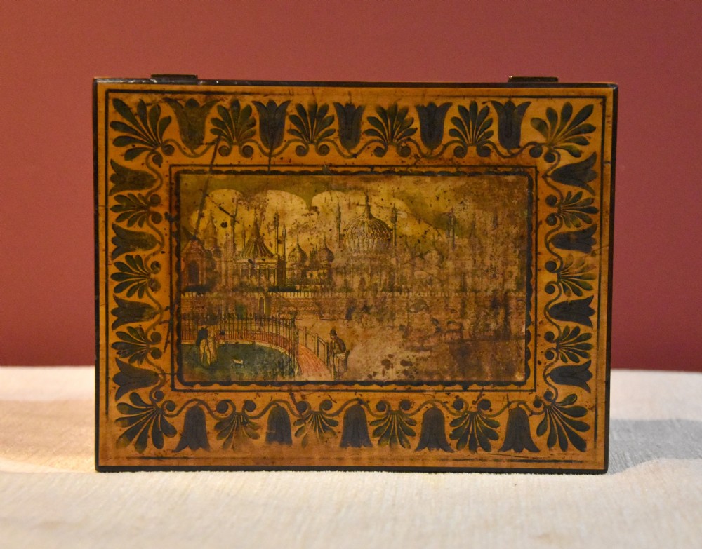 A rectangular 19th-century sycamore wood box featuring a printed architectural scene on the lid surrounded by a stylized leaf border and a keyhole on the front. View IV