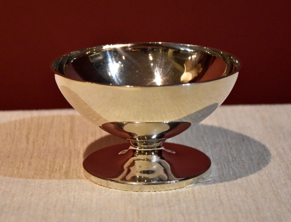 A polished George III sterling silver footed pedestal bowl with a plain circular body and spreading circular foot.